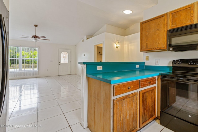 kitchen with black appliances, lofted ceiling, a ceiling fan, brown cabinets, and light tile patterned flooring