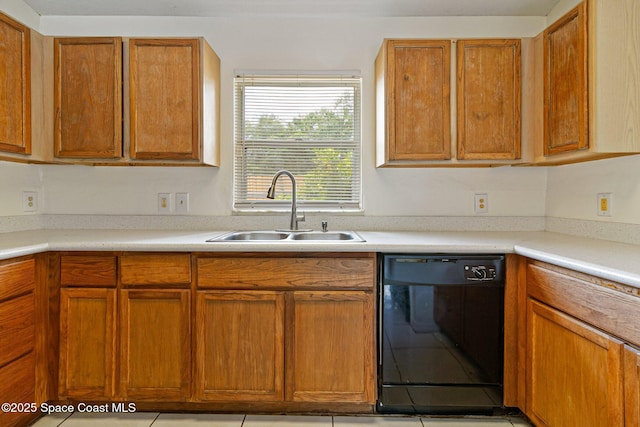 kitchen with black dishwasher, a sink, brown cabinetry, and light countertops