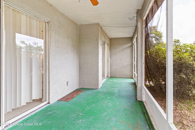 unfurnished sunroom with ceiling fan and healthy amount of natural light