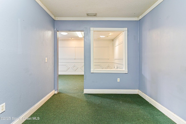carpeted empty room featuring baseboards