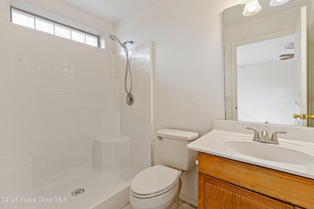 full bathroom with vanity, a shower, and toilet