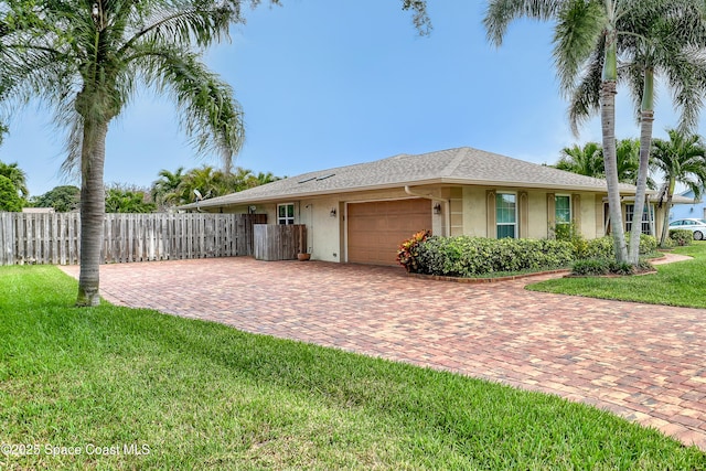 view of front of property featuring a garage, stucco siding, fence, a front lawn, and decorative driveway