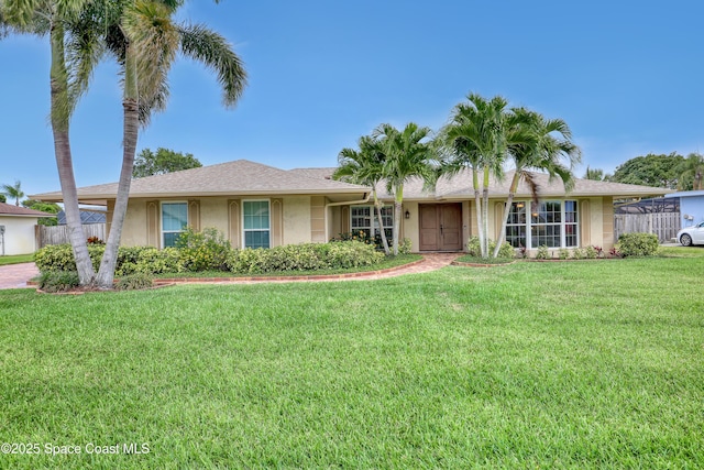 ranch-style home with stucco siding and a front lawn