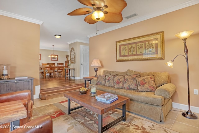 living area featuring ornamental molding, ceiling fan with notable chandelier, light tile patterned floors, and visible vents