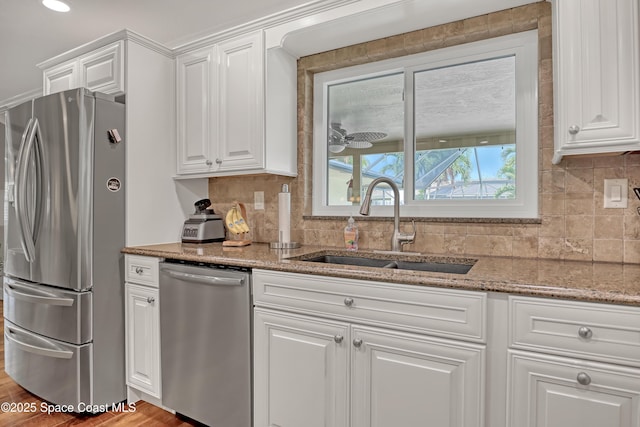 kitchen featuring a sink, white cabinetry, and appliances with stainless steel finishes
