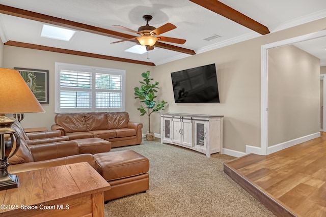 living room featuring visible vents, crown molding, ceiling fan, carpet flooring, and baseboards