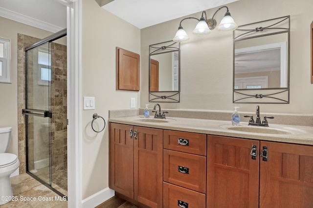 full bathroom featuring toilet, a stall shower, ornamental molding, and a sink