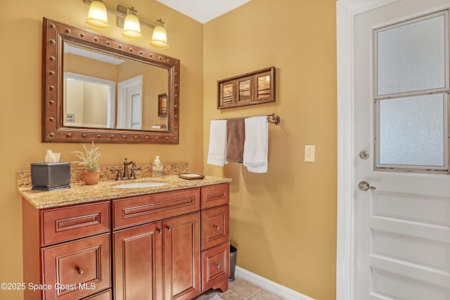 bathroom with baseboards, tile patterned floors, and vanity