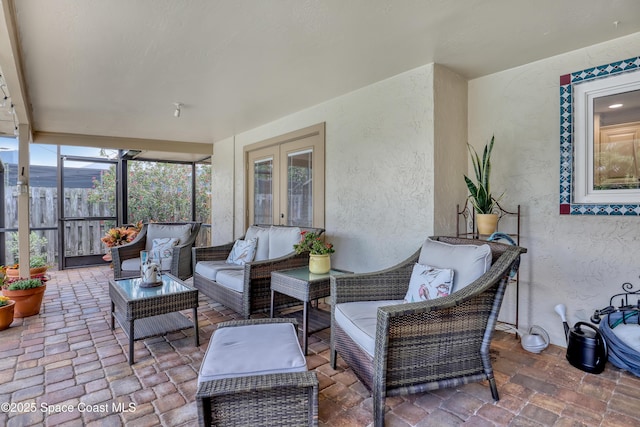 sunroom / solarium with french doors and an outdoor living space