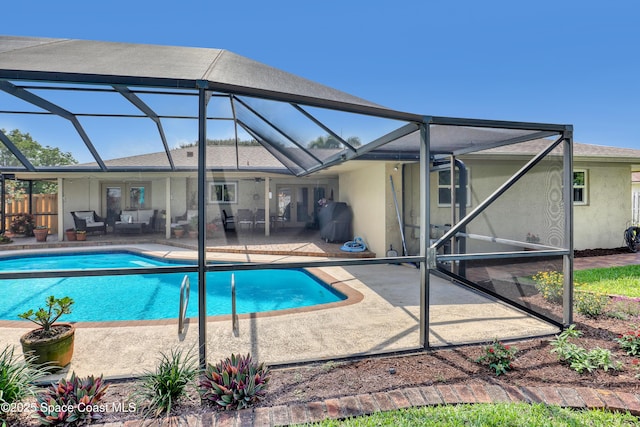 pool featuring a lanai, a patio, an outdoor hangout area, and french doors