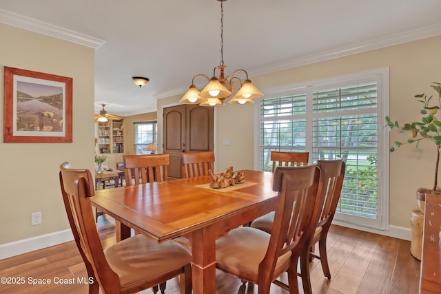 dining area featuring crown molding, light wood-type flooring, and baseboards