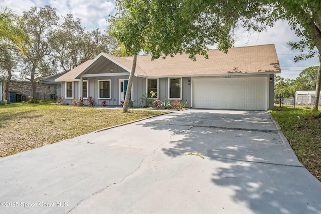 1680 Travis St SE, Palm Bay, FL 32909 - ranch-style home with board and batten siding, driveway, an attached garage, a front lawn, and covered porch
