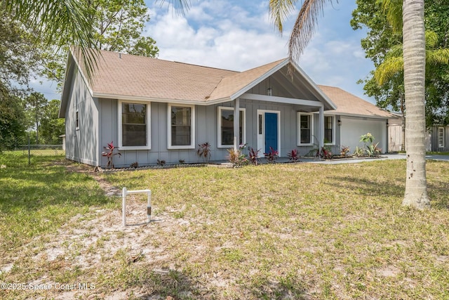 1680 Travis St SE, Palm Bay, FL 32909 - ranch-style house with board and batten siding, a shingled roof, and a garage