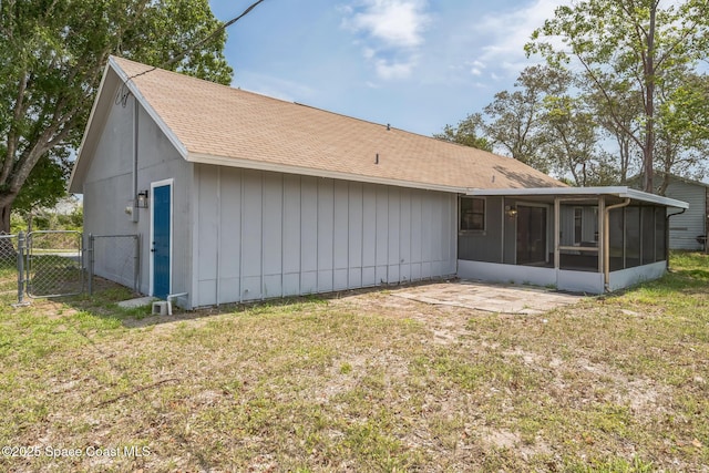 1680 Travis St SE, Palm Bay, FL 32909 - back of house featuring a gate, a sunroom, and a shingled roof