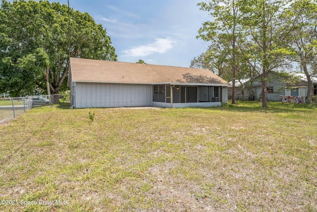 1680 Travis St SE, Palm Bay, FL 32909 - rear view of house featuring a sunroom and roof with shingles