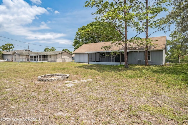 1680 Travis St SE, Palm Bay, FL 32909 - view of green lawn with a sunroom and a fire pit