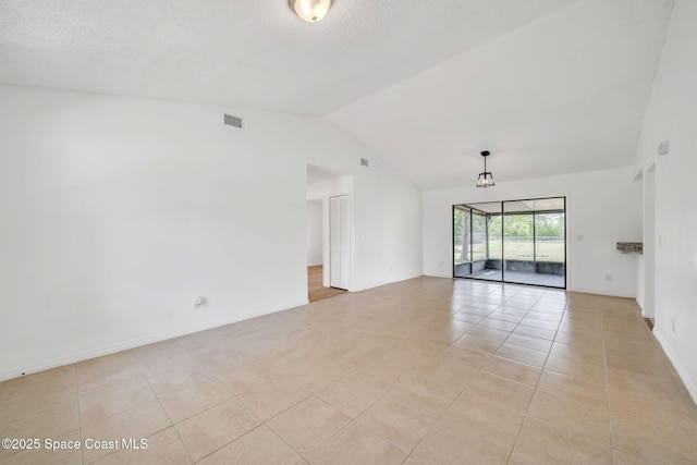 1680 Travis St SE, Palm Bay, FL 32909 - empty room with vaulted ceiling and light tile patterned flooring