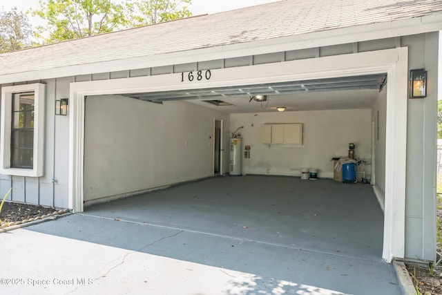 1680 Travis St SE, Palm Bay, FL 32909 - garage with electric water heater, a garage door opener, and driveway