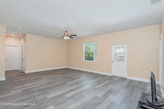 unfurnished living room with a ceiling fan, recessed lighting, baseboards, visible vents, and wood finished floors