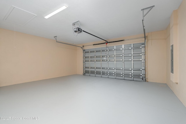 garage featuring electric panel and a garage door opener