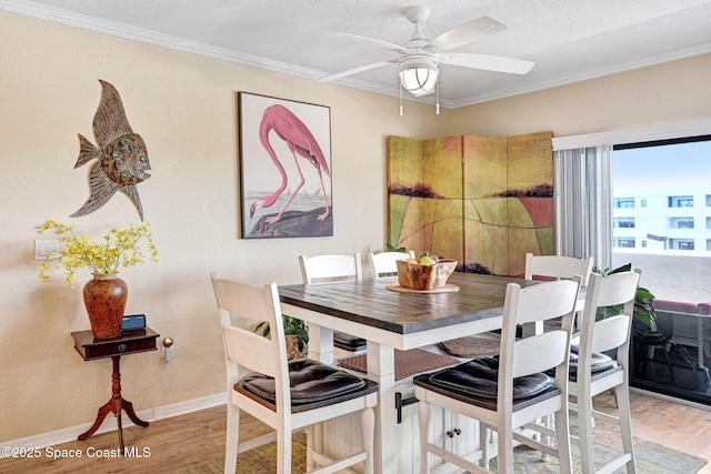 5011 Dixie Hwy NE Unit A312, Palm Bay, FL 32905 - dining area featuring wood finished floors, ornamental molding, baseboards, and ceiling fan