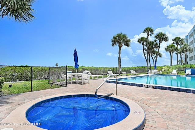 5011 Dixie Hwy NE Unit A312, Palm Bay, FL 32905 - community pool featuring a hot tub, fence, and a patio