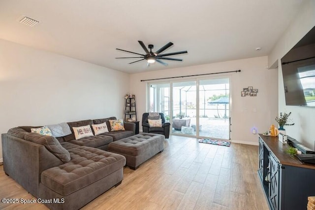 2979 Pangea Cir, Melbourne, FL 32940 - living area featuring light wood-style flooring, ceiling fan, and baseboards
