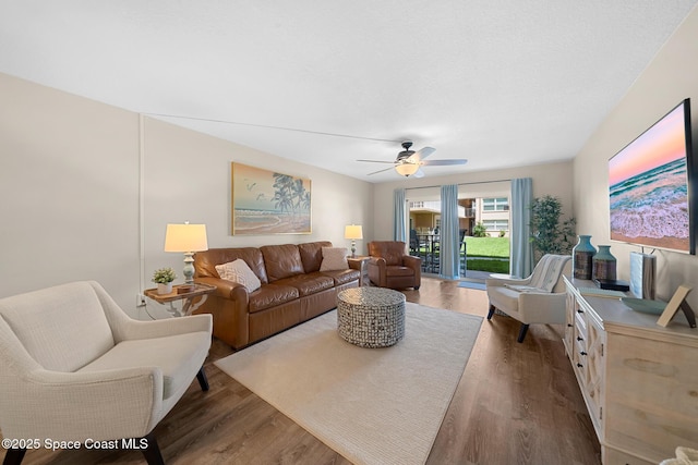 living room with ceiling fan and wood finished floors