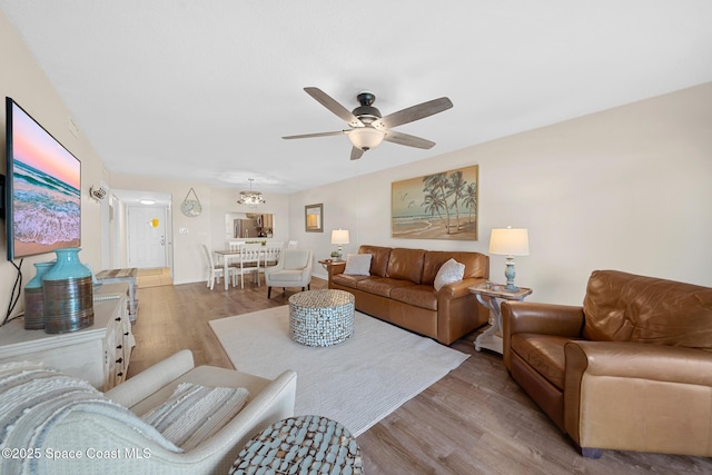 living room featuring wood finished floors and a ceiling fan