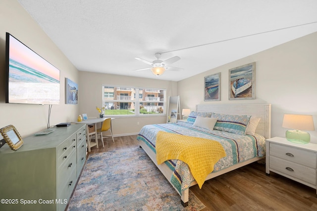 bedroom featuring baseboards, a ceiling fan, and wood finished floors