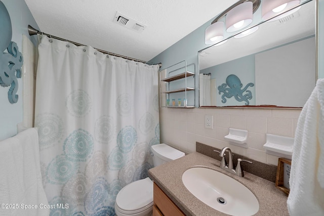 full bathroom featuring toilet, tile walls, vanity, visible vents, and backsplash