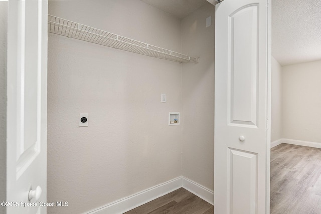 laundry area with wood finished floors, hookup for a washing machine, baseboards, and electric dryer hookup