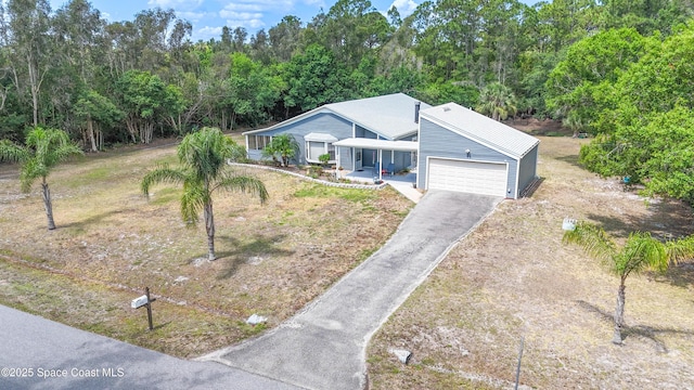 2530 State St, Melbourne, FL 32904 - ranch-style house featuring an attached garage, driveway, and covered porch