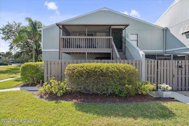 view of front of house featuring stairs, a front yard, and fence