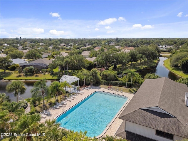 community pool with a water view, a patio area, and a pergola