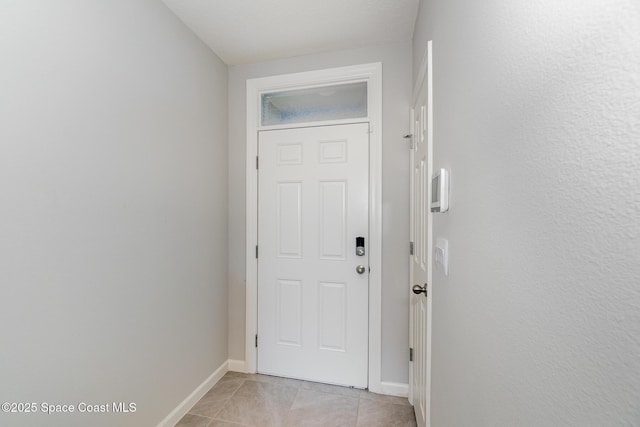 entryway featuring light tile patterned floors and baseboards