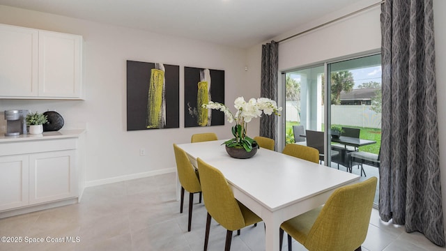 dining area with baseboards and light tile patterned floors