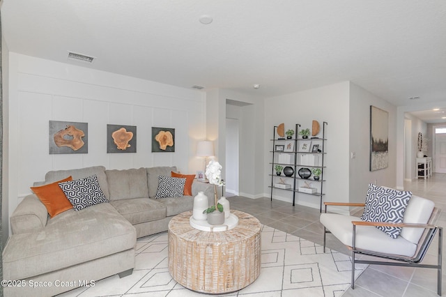 living room featuring light tile patterned floors and visible vents