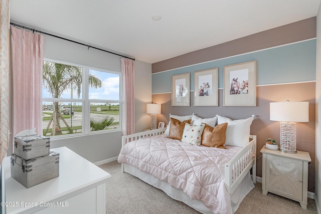 carpeted bedroom with baseboards