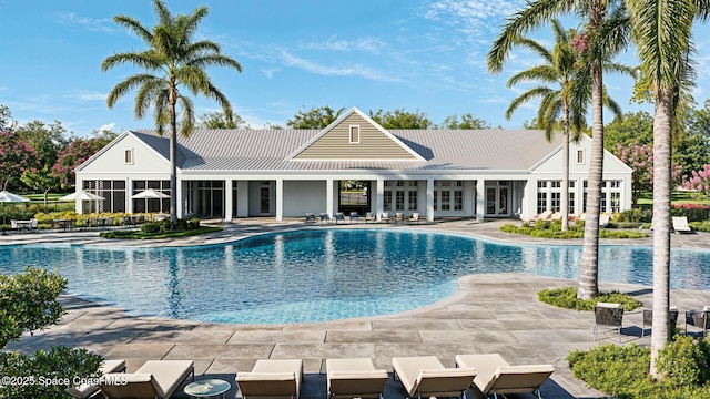 community pool with a patio and french doors