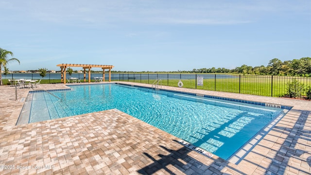 pool with fence, a water view, a pergola, and a patio area