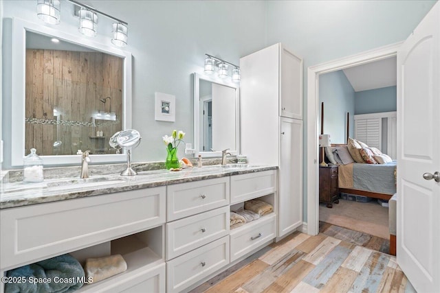 505 Tradewinds Dr, Indian Harbour Beach, FL 32937 - ensuite bathroom featuring a sink, a walk in shower, double vanity, and wood finished floors
