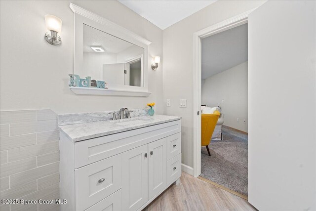 505 Tradewinds Dr, Indian Harbour Beach, FL 32937 - bathroom with vanity and wood finished floors