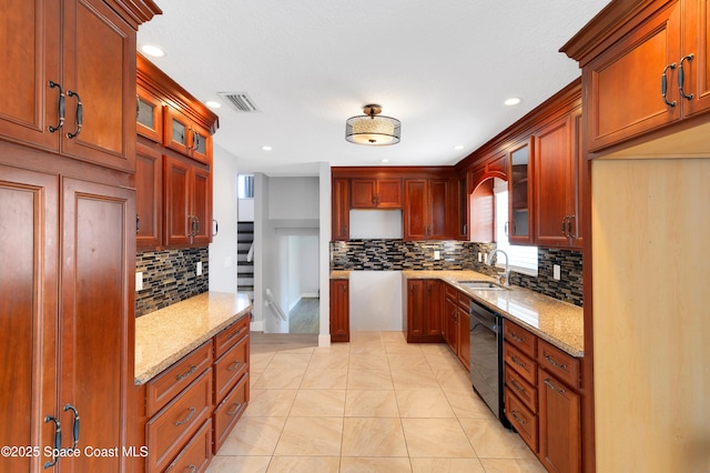 kitchen with light stone countertops, backsplash, a sink, black dishwasher, and recessed lighting