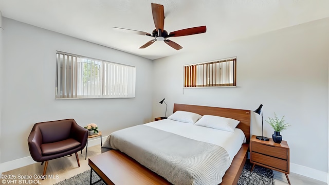 bedroom with baseboards, wood finished floors, and ceiling fan