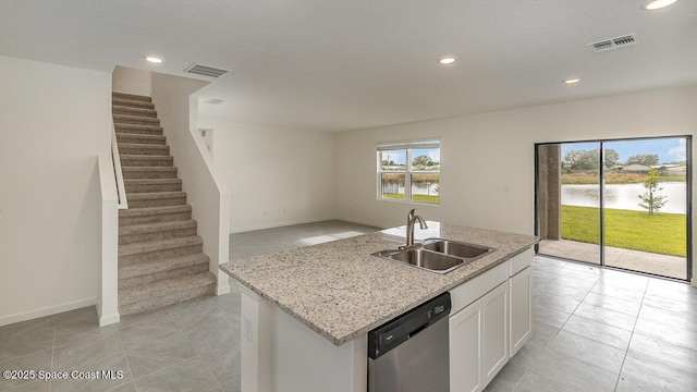 kitchen featuring dishwasher, visible vents, open floor plan, and a sink