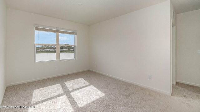 empty room with carpet and baseboards