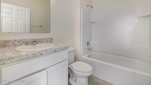 bathroom featuring toilet, washtub / shower combination, tile patterned floors, and vanity