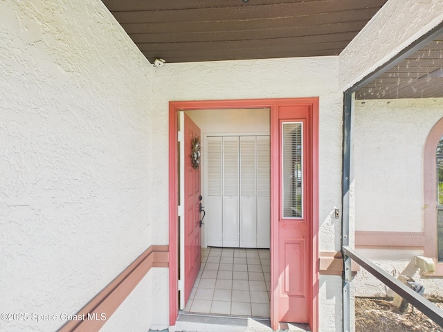entrance to property featuring stucco siding