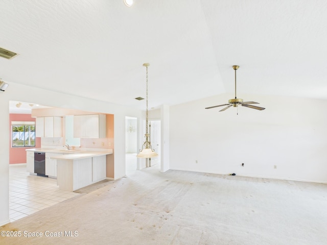 kitchen featuring a peninsula, black dishwasher, open floor plan, a ceiling fan, and light countertops